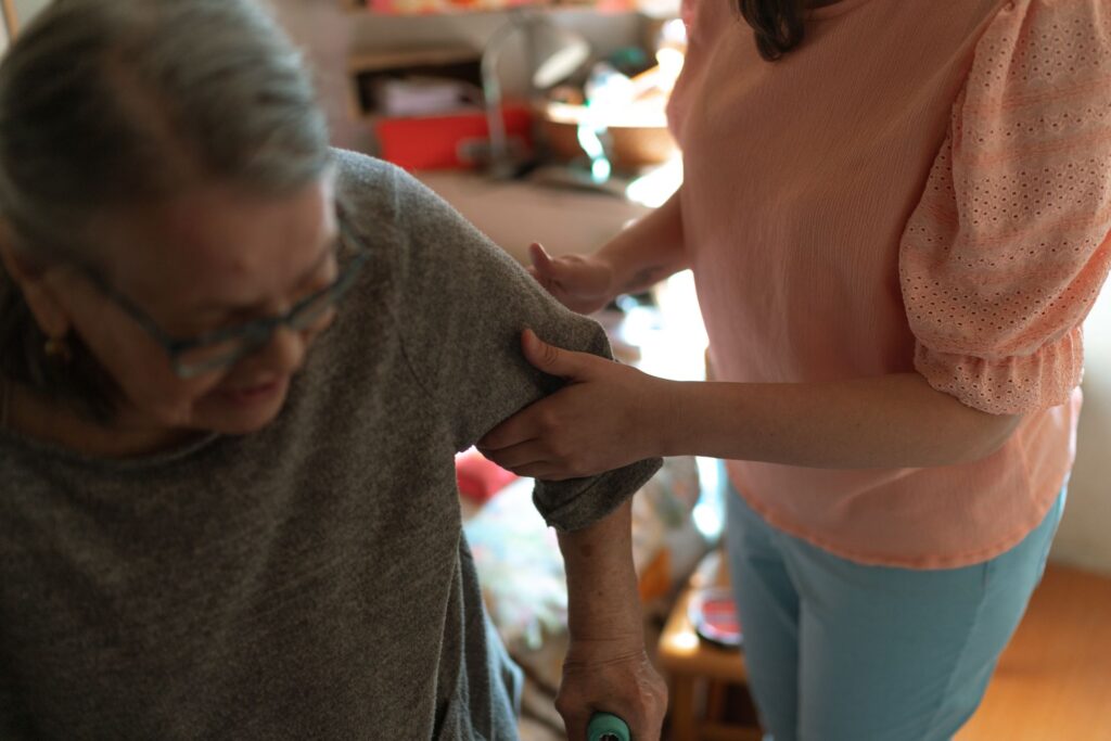 Caregiver helping an older woman at home