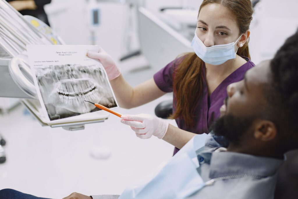 Patient discussing dental X-ray results with a dentist