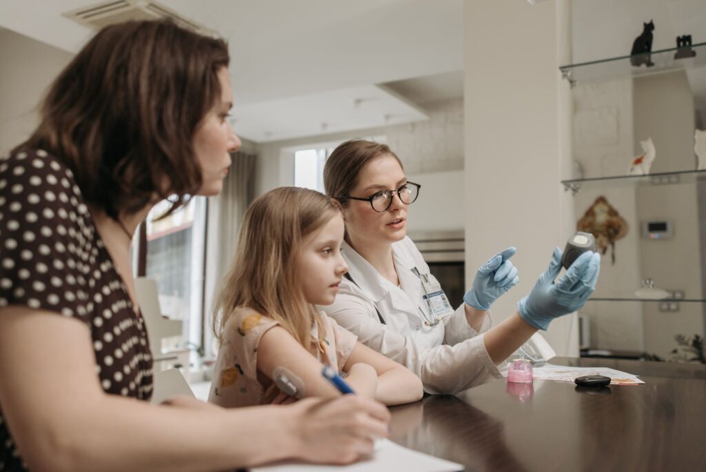 Mother and daughter consulting a doctor during a home visit