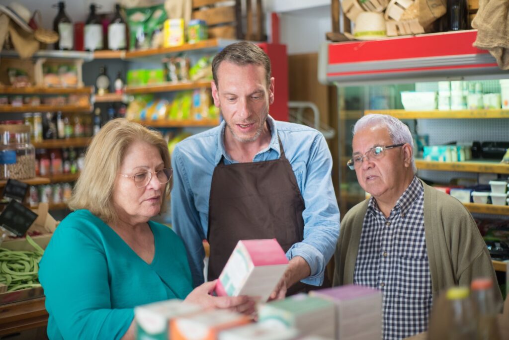 Customers discussing medication with a pharmacist
